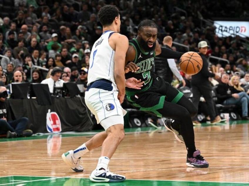 Boston's Jaylen Brown drives to the basket against Josh Green in the Celtics' NBA victory