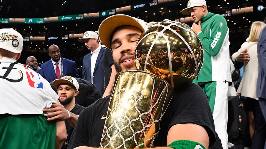 Jayson Tatum with Larry O'Brien Trophy