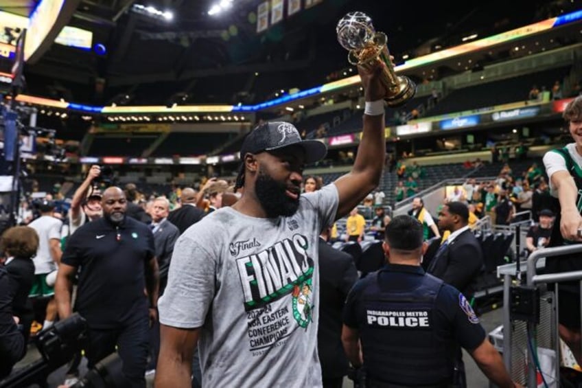 Jaylen Brown of the Boston Celtics raises The Larry Bird Trophy awarded to the MVP of the