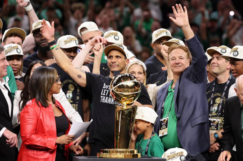 Head coach Joe Mazzulla of the Boston Celtics celebrates in front of the Larry O’Brien Championship Trophy after Boston's 106-88 win against the...