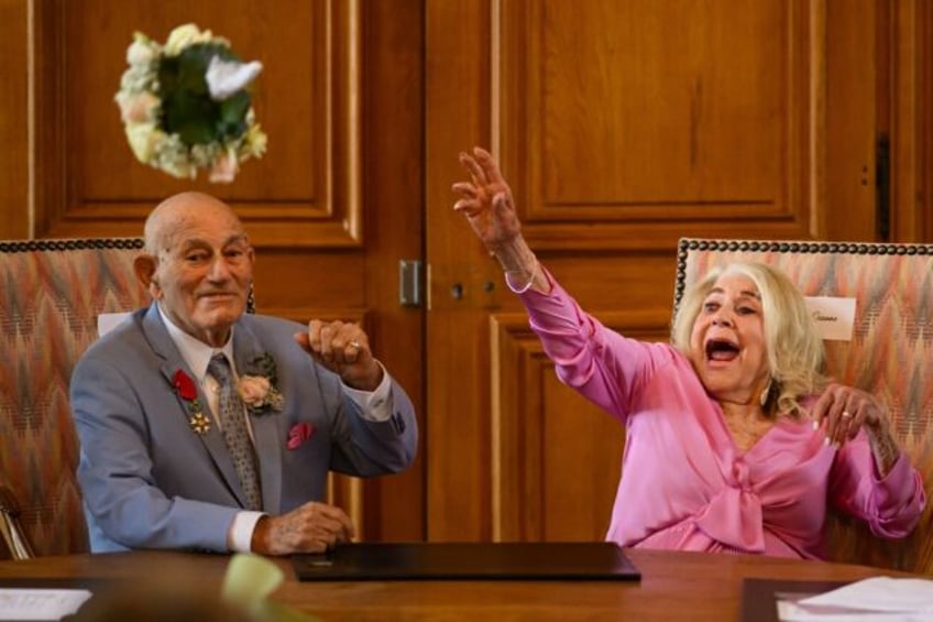 Jeanne Swerlin, 96, throws her bouquet of flowers after officialising her marriage to US W