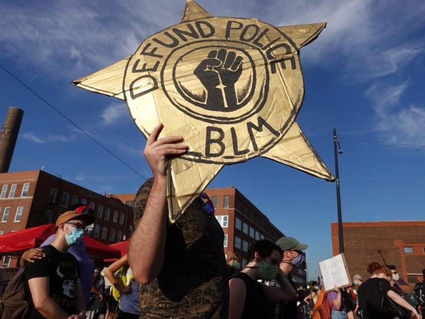 CHICAGO, ILLINOIS - JULY 24: Activists hold a rally calling for the defunding of police in