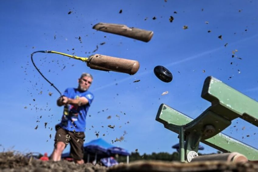 A player splits the wooden end of his stick while striking the hornuss