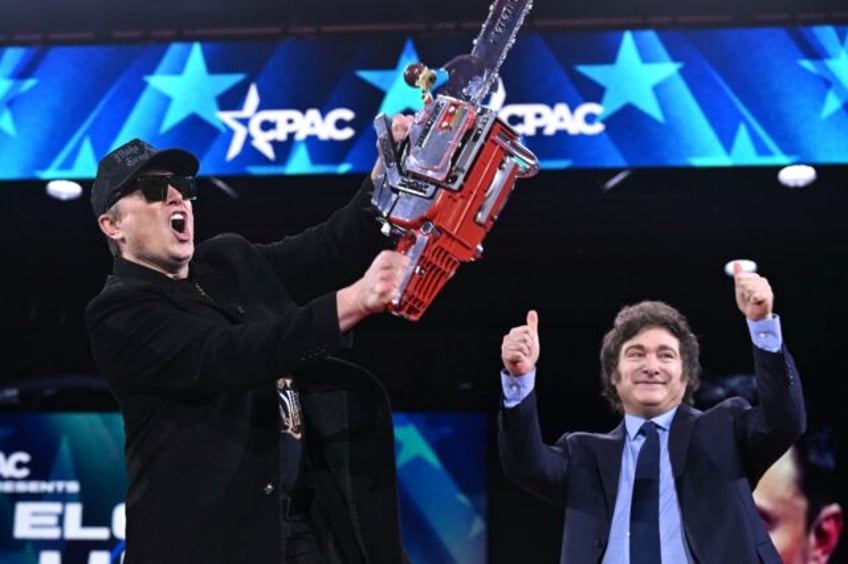 Elon Musk holds a chainsaw alongside Argentine President Javier Milei during the annual Co