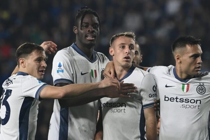 Inter Milan midfielder Davide Frattesi surrounded by his teammates after his first goal ag