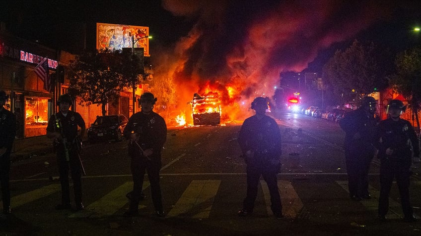 LAPD standing in front of burning bus