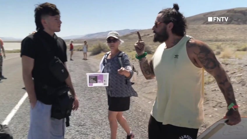 chaotic video shows police breaking up burning man climate protest blocking road and causing traffic jam