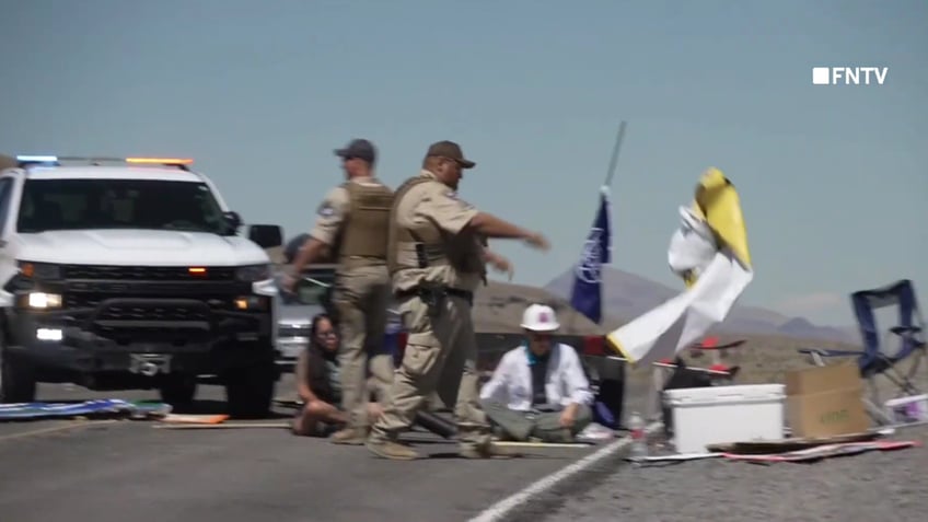 chaotic video shows police breaking up burning man climate protest blocking road and causing traffic jam