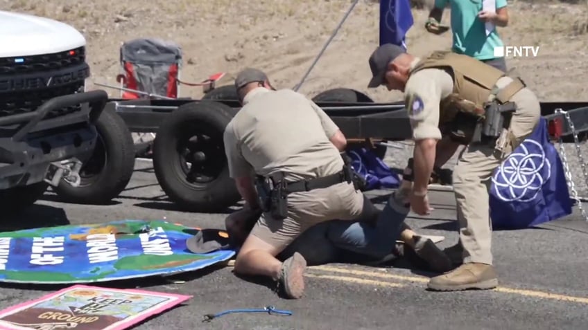 chaotic video shows police breaking up burning man climate protest blocking road and causing traffic jam