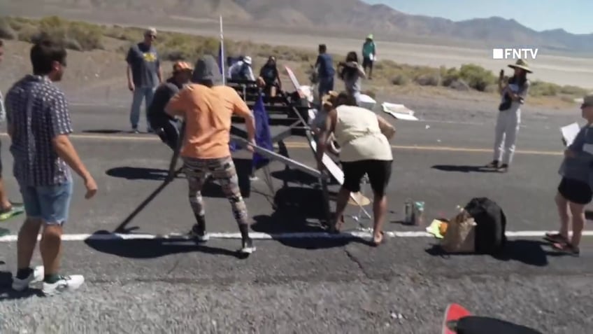 chaotic video shows police breaking up burning man climate protest blocking road and causing traffic jam