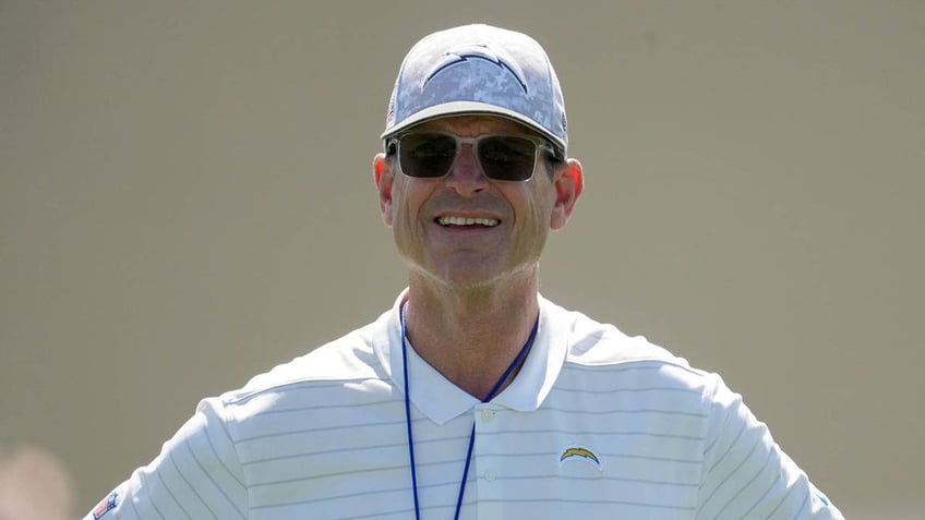 Jim Harbaugh looks on