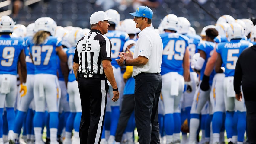 Jim Harbaugh talks with NFL ref