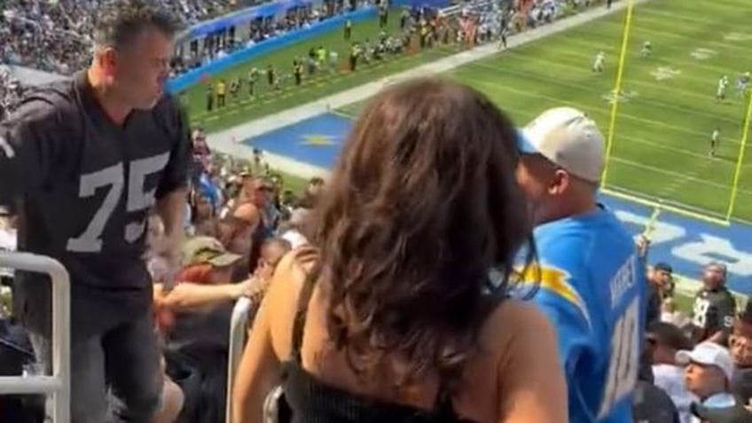 chargers raiders fans come to blows during game at sofi stadium