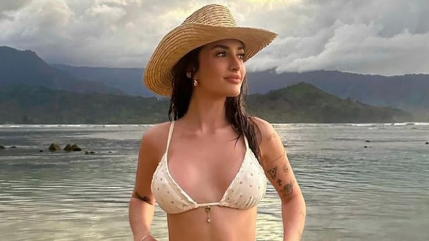 Sami Sheen in hat and bikini top