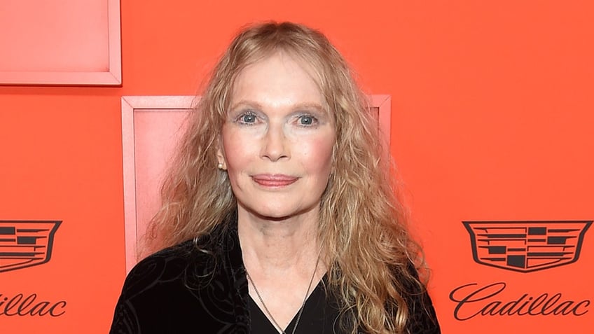 Mia Farrow wears black dress on red carpet