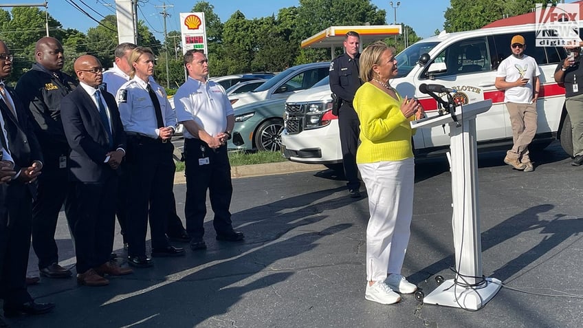 Mayor Lyles wearing yellow as she speaks to the press