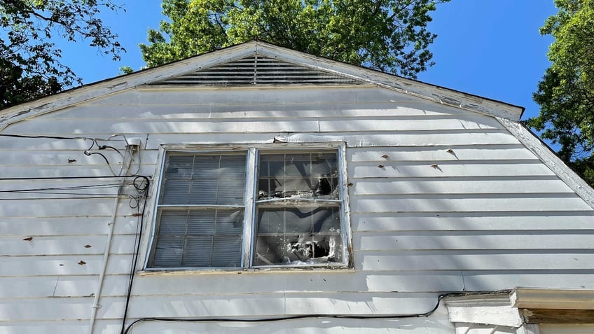 Bullet holes seen on the siding of the house where the Charlotte shootout took place