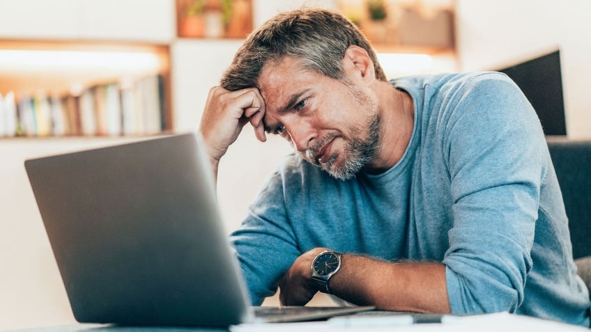 Man frustrated at computer