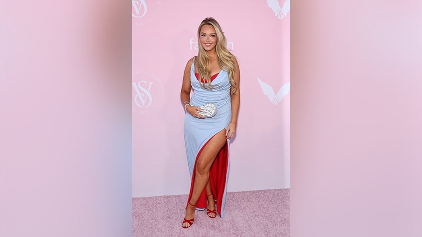 Camlile Kostek wore a blue gown with a thigh-high slit while on the Victoria's Secret red carpet.