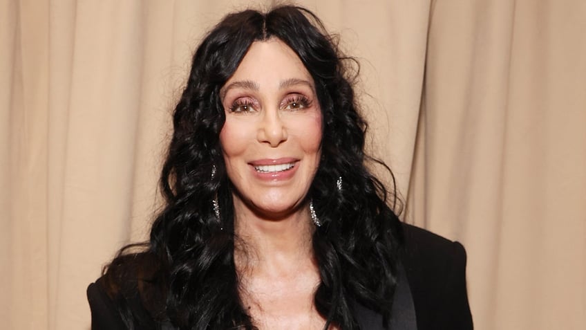 Singer Cher wears black blazer and silver hoop earrings