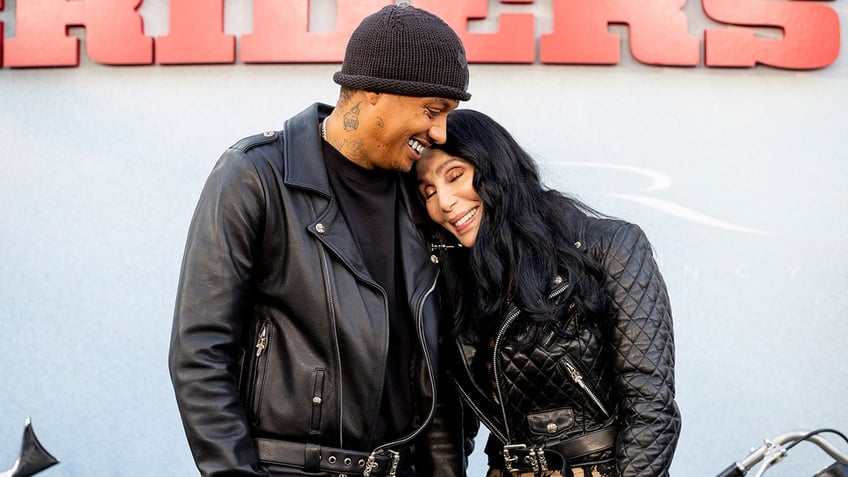 Cher and her boyfriend, Alexander Edwards, cuddled while posing for photos at the premiere of "The Bikeriders."