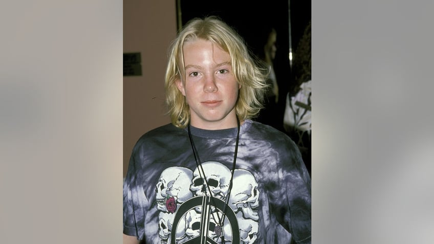 A close-up of young Elijah Blue wearing a t-shirt with skulls.