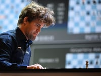 Chess great Carlsen held to draw by 143,000 players