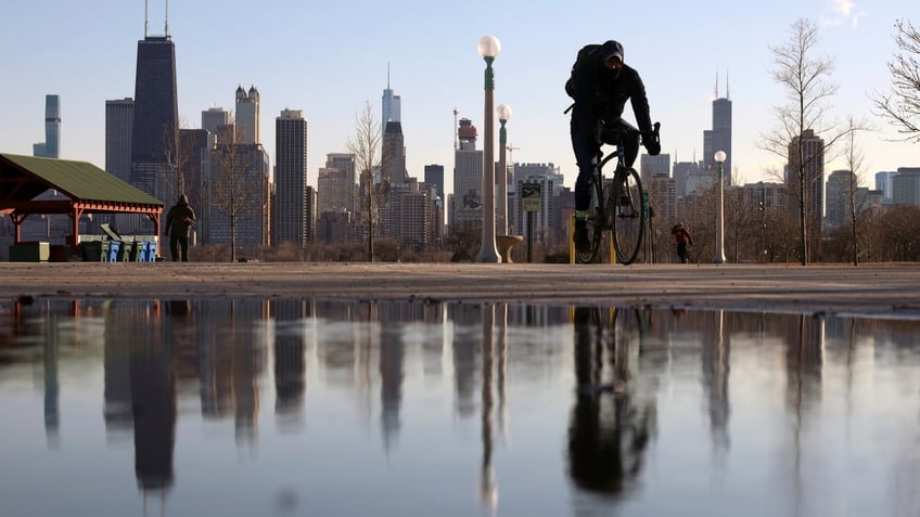 Photo showing biker riding in front of Chicago skyline