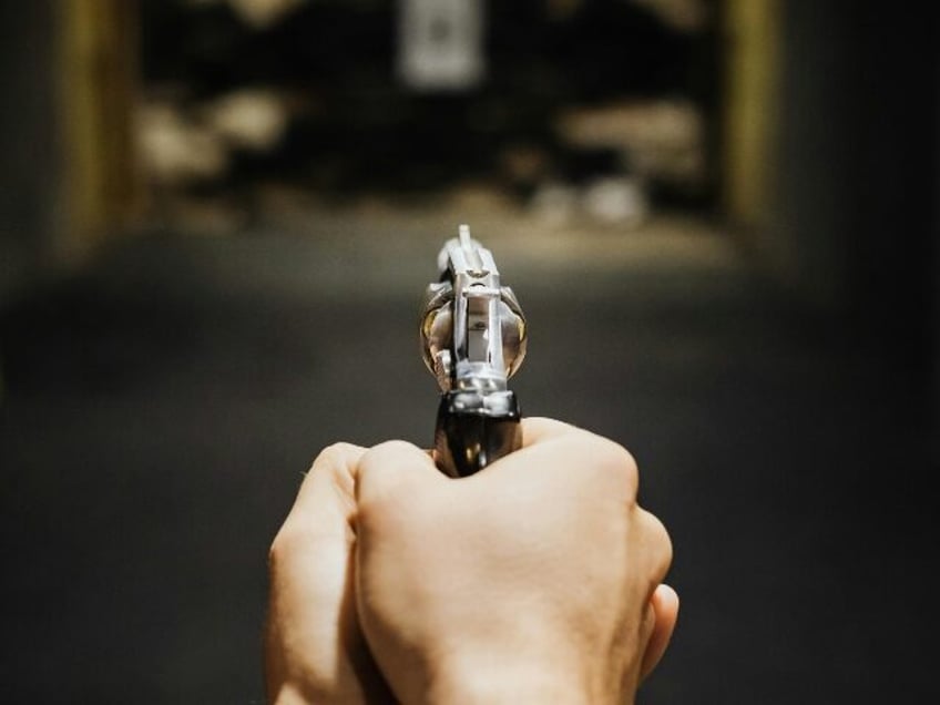 Hands of a Person Aiming a Handgun