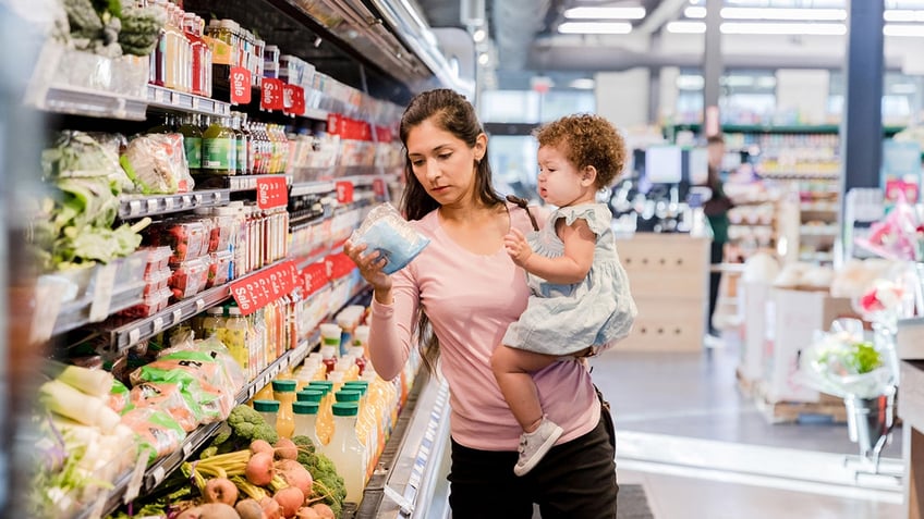 mom with daughter in produce aisle