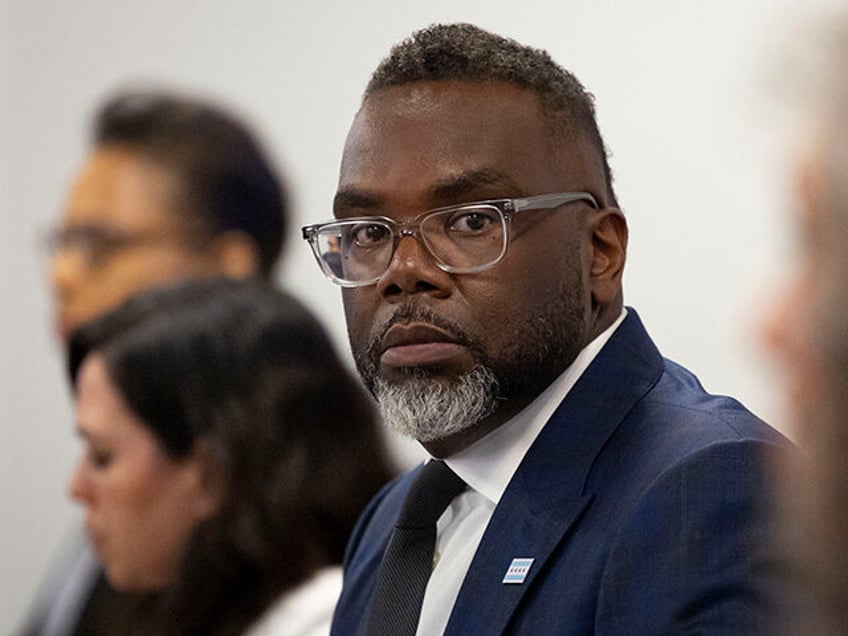 Mayor Brandon Johnson listens while other officials speak during a press briefing on June