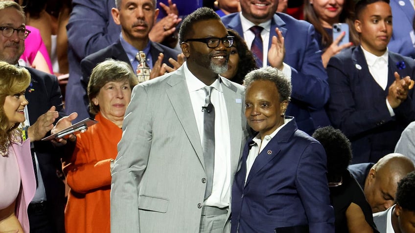 Brandon Johnson stands with then-Mayor Lori Lightfoot before he is sworn in as Chicago mayor on May 15, 2023, at the University of Illinois at Chicago.