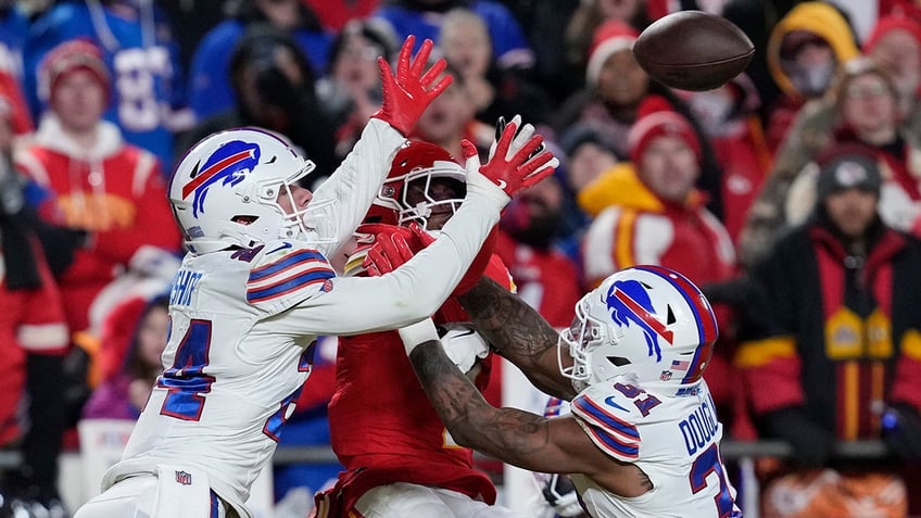 Xavier Worthy jumps for the ball