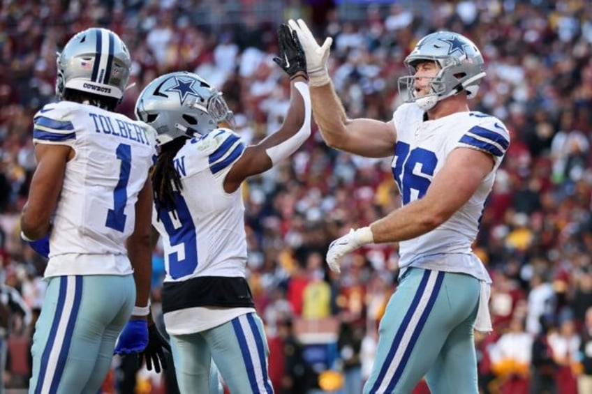 Luke Schoonmaker of the Dallas Cowboys celebrates a fourth-quarter touchdown catch as the