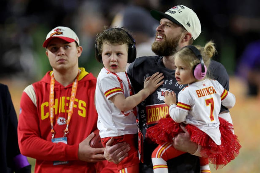 Harrison Butker of the Kansas City Chiefs celebrates with his children after kicking the go ahead field goal to beat the Philadelphia Eagles in Super...