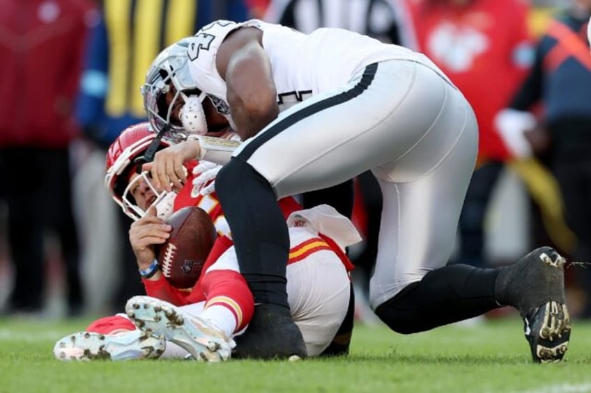 Kansas City quarterback Patrick Mahomes is sacked by K'Lavon Chaisson of the Las Vegas Rai