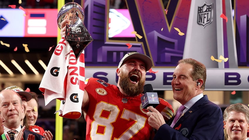 Travis Kelce holds the Lombardi Trophy