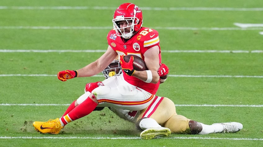 Travis Kelce dragged down