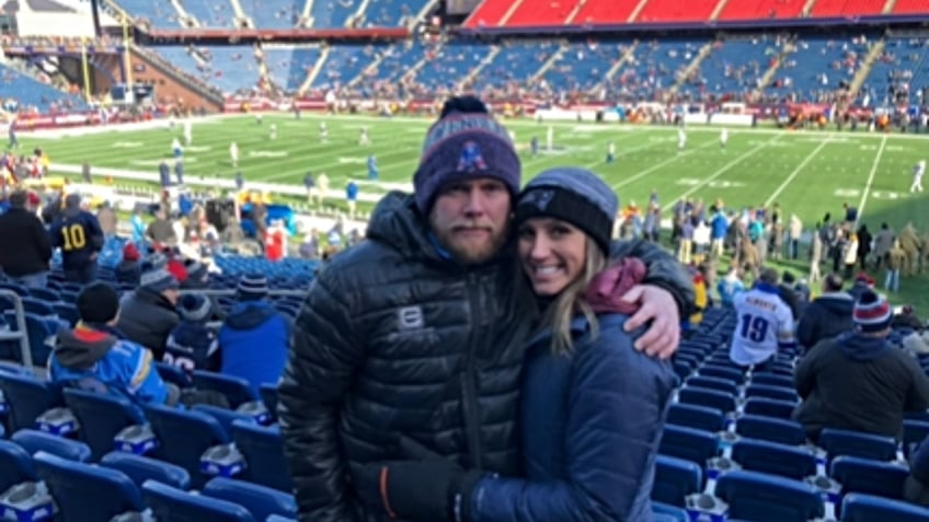 Eric and Kouri Richins at a football game