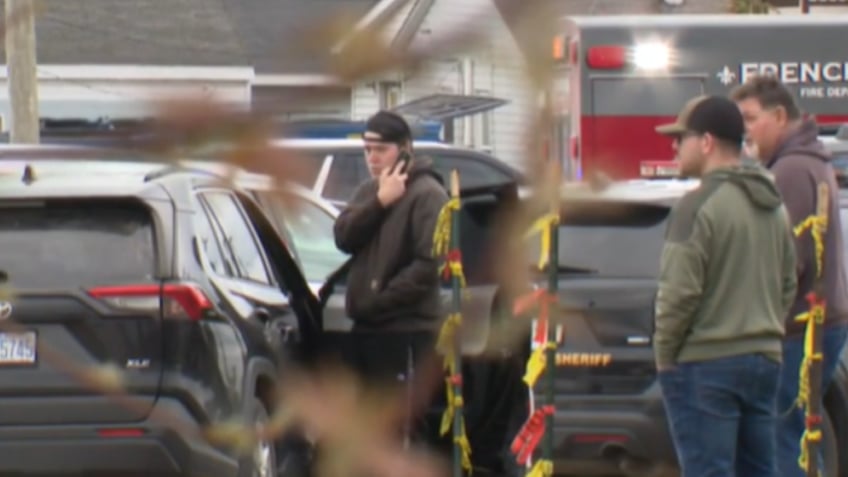 Man holding phone near ambulance