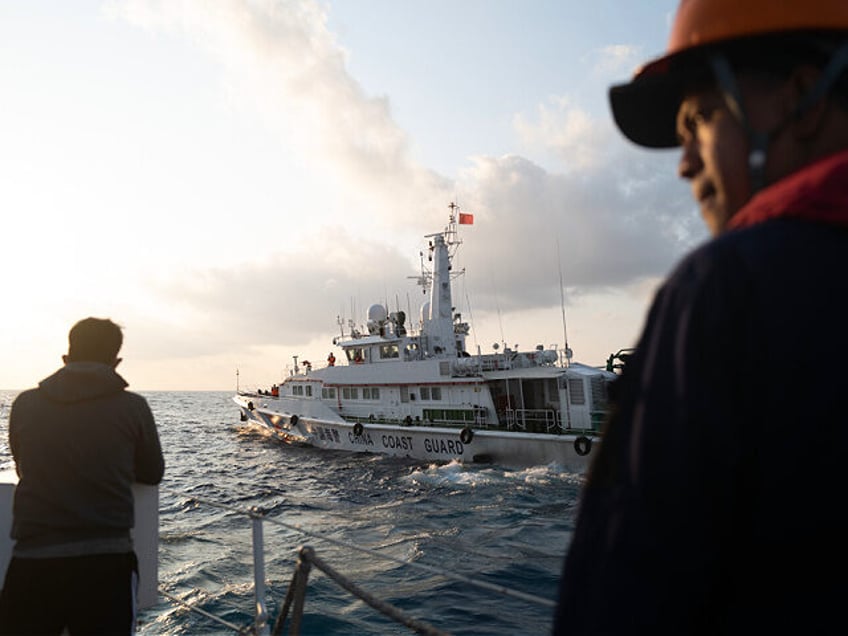 AT SEA, CHINA - MARCH 23: Chinese Coast Guard vessels execute a dangerous maneuver against