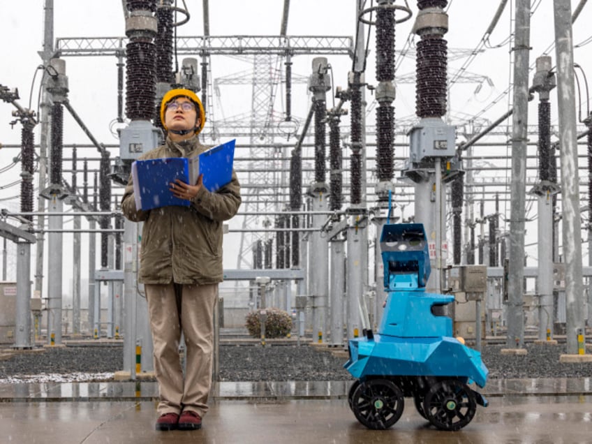 Power Inspection During Cold Wave TAIZHOU, CHINA - DECEMBER 18, 2023 - A robot assisted by power personnel makes a snowy inspection of a substation in Taizhou, Jiangsu province, China, December 18, 2023. (Photo credit should read CFOTO/Future Publishing via Getty Images)