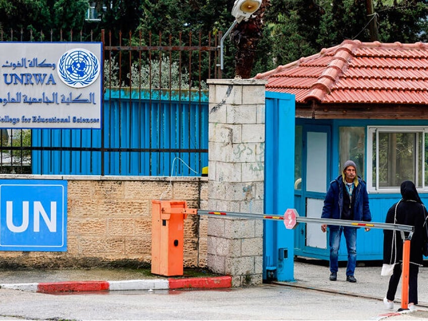 Palestinians stand at the entrance of the UNRWA-run University College for Educational Science Ramallah city in the occupied West Bank on January 29, 2024. UN Secretary-General Antonio Guterres pleaded for continued support for UNRWA, the United Nations agency for Palestinian refugees, which is threatened by a fierce row over alleged …