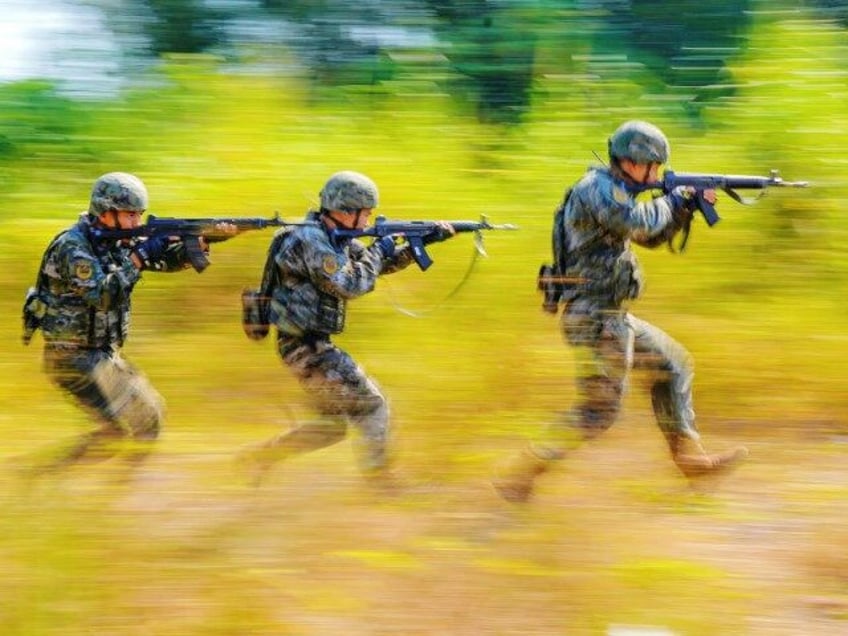 People's Armed Police conduct a mountain and forest combat drill in Qinzhou, China, on Oct