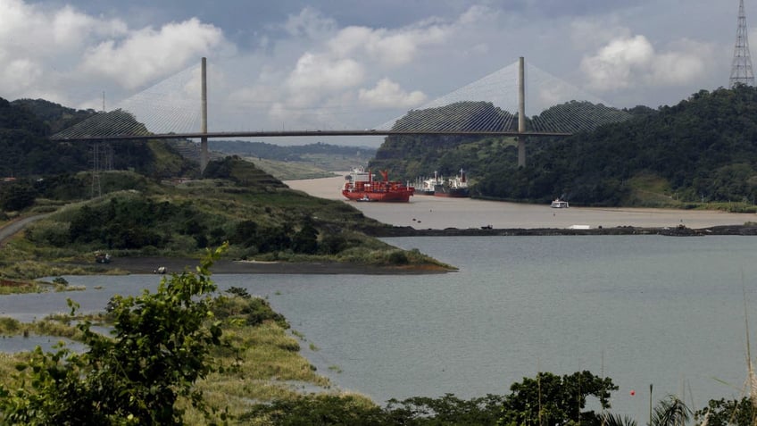 A cargo boat navigates on the Panama Canal next to the expansion project of the Panama Canal on the pacific side in Panama City