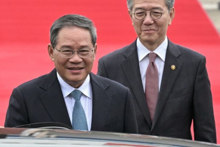 Chinese Premier Li Qiang (L, with South Korea's Vice Foreign Minister Kim Hong-kyun) arriv