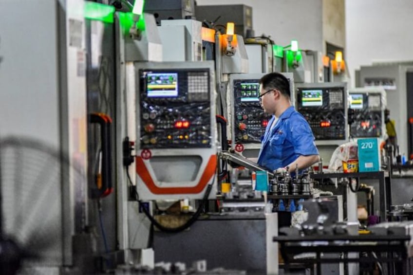 A worker on a production line at a printing and packaging factory in Qingzhou, eastern Chi