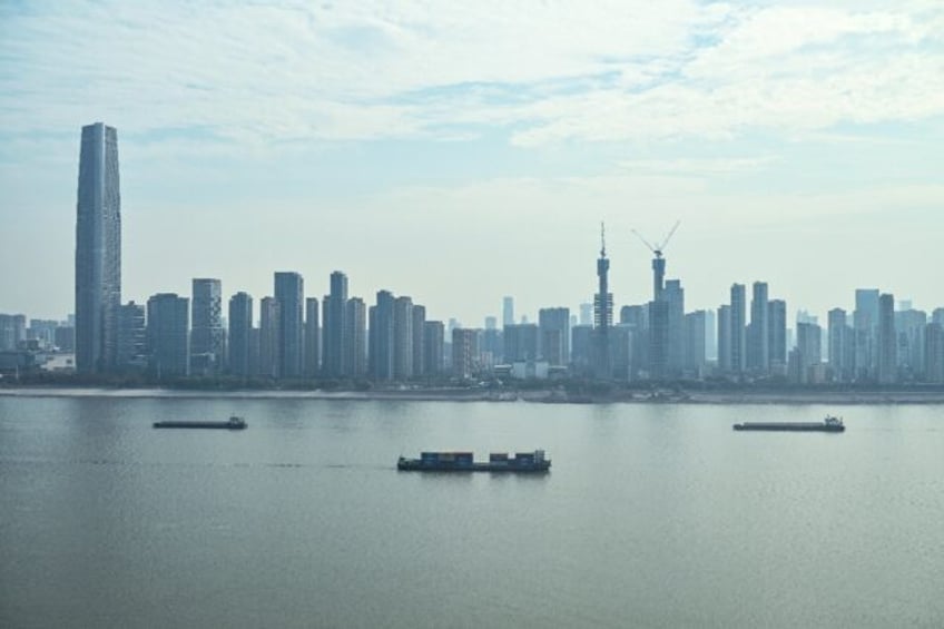 Cargo ships sail on the Yangtze River in Wuhan, where the Covid-19 virus originated