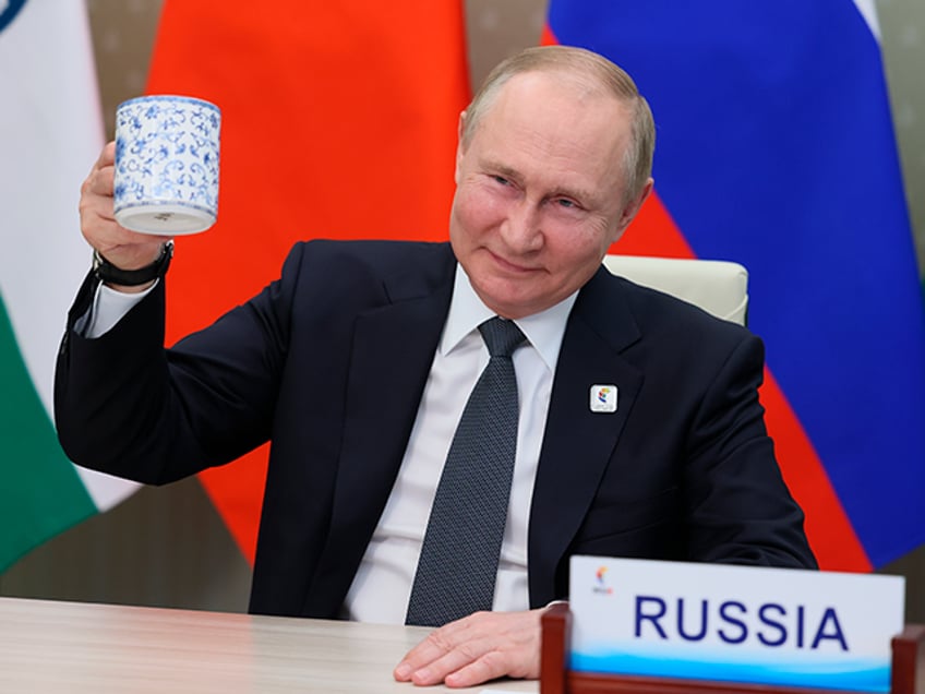 Russian President Vladimir Putin makes a toast as he takes part in a virtual format at the opening ceremony of the BRICS Business Forum via videoconference in Moscow region, in Moscow, Russia, Thursday, June 23, 2022. (Mikhail Metzel/Sputnik, Kremlin Pool Photo via AP)