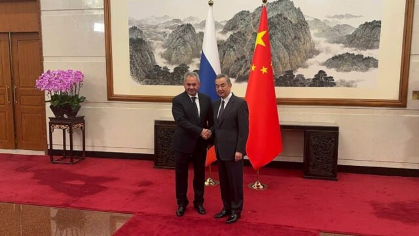 Senior Russian official Sergei Shoigu (L) met China's foreign minister Wang Yi (R) in Beij